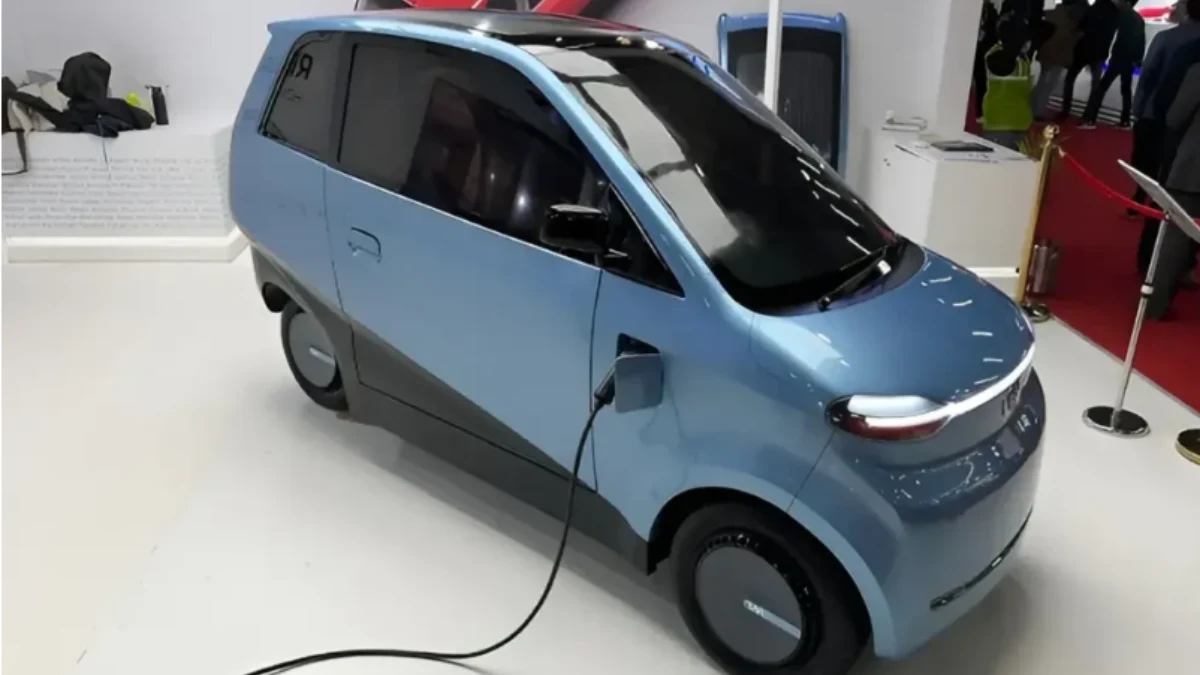 Sleek solar-powered car driving on a highway with sunlight shining on solar panels