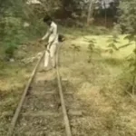 A staff member of HDMC clears the toy train track at MG Park