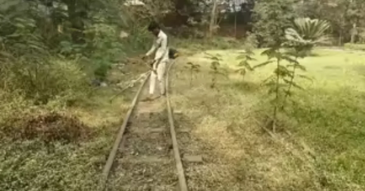 A staff member of HDMC clears the toy train track at MG Park