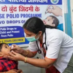 Pulse Polio programme in Hubballi where healthcare worker gives polio drops to a child