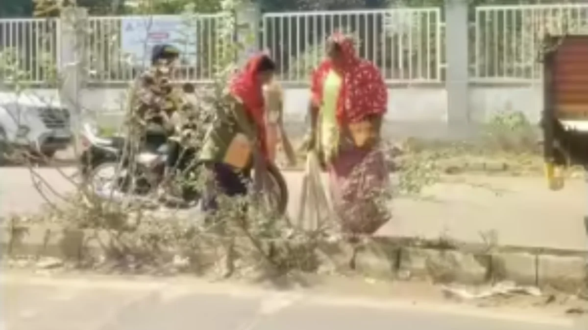 Wide-angle view of Hubballi-Dharwad city main road during cleanliness drive, sanitation workers cleaning roads