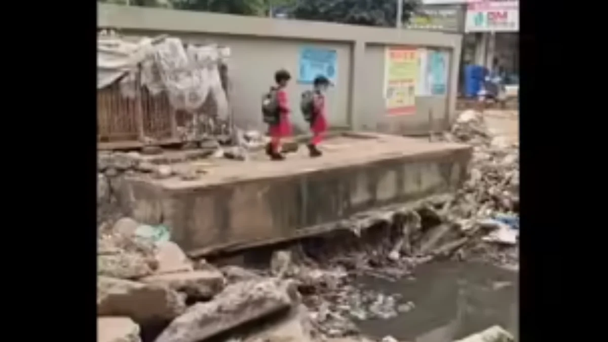 Two schoolchildren seen crossing the Rajanala at Myadar Oni in Hubballi