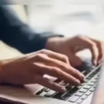 Student checking JEE Main 2026 result and scorecard on official NTA website on laptop