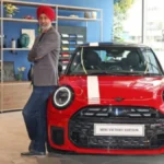 Mini Cooper S Victory Edition in red color with racing stripes parked outdoors