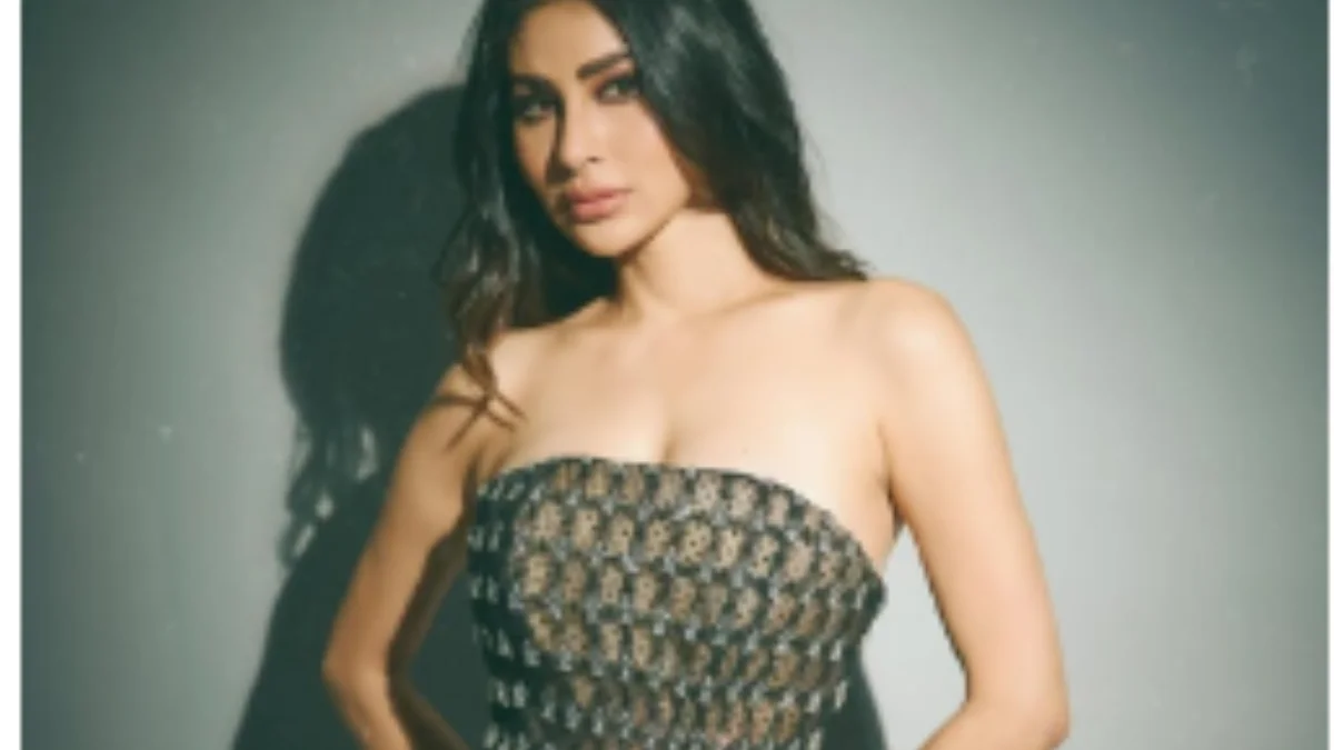 Mouni Roy wearing a dark green embellished strapless ballgown during a glamorous fashion photoshoot with elegant styling and soft makeup.